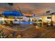 Night view of a backyard pool and lounge area at 4942 E Wethersfield Rd, Scottsdale, AZ 85254