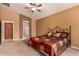 Comfortable bedroom featuring carpet floors, ceiling fan, and ensuite bathroom with glass shower at 5126 S Sugarberry Ct, Gilbert, AZ 85298