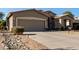 House exterior with a two-car garage and rock landscaping at 5126 S Sugarberry Ct, Gilbert, AZ 85298