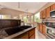 The bright eat-in kitchen boasts granite counters, stainless appliances, and views to the manicured backyard at 5126 S Sugarberry Ct, Gilbert, AZ 85298