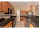 Updated kitchen features granite countertops, tile backsplash, stainless appliances, and wood cabinets at 5126 S Sugarberry Ct, Gilbert, AZ 85298