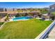 Beautiful aerial view of the backyard with a sparkling pool, lush lawn, and ample space for outdoor entertainment at 5528 E Windstone Trl, Cave Creek, AZ 85331