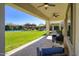 Open backyard featuring a green lawn, covered patio seating areas, a pool with water fountains, and lush landscaping at 5528 E Windstone Trl, Cave Creek, AZ 85331