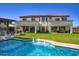 Back of house with a large in ground pool, water features, and a beautiful green lawn at 5528 E Windstone Trl, Cave Creek, AZ 85331