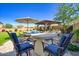 Charming outdoor patio with a dining table, grill, and bar seating overlooking the refreshing swimming pool at 5528 E Windstone Trl, Cave Creek, AZ 85331