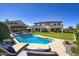 Beautiful in-ground pool and backyard oasis with fountain features, green grass, and comfortable patio seating at 5528 E Windstone Trl, Cave Creek, AZ 85331