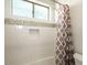 Neutral bathroom features a shower/tub combo with decorative tiles and a shower curtain at 5528 E Windstone Trl, Cave Creek, AZ 85331