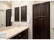 Bathroom featuring dark wood cabinetry, double sinks, mirrors and dark wood storage cabinets at 5528 E Windstone Trl, Cave Creek, AZ 85331