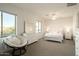 Well-lit bedroom featuring a white bed with pink accents, a papasan chair, and two large windows at 5528 E Windstone Trl, Cave Creek, AZ 85331