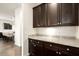 A butler's pantry features dark wood cabinets and a granite countertop at 5528 E Windstone Trl, Cave Creek, AZ 85331