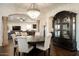 Dining area with a crystal chandelier, elegant decor, and seamless flow to living space at 5528 E Windstone Trl, Cave Creek, AZ 85331