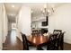Elegant dining room with stylish chandelier and wood floors provides a perfect gathering space with a natural feel at 5528 E Windstone Trl, Cave Creek, AZ 85331