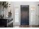 Inviting entryway with a dark wood door flanked by shuttered windows and stylish decor at 5528 E Windstone Trl, Cave Creek, AZ 85331
