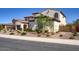 Elegant home with a neutral facade, decorative windows, and a meticulously landscaped front yard with mature trees at 5528 E Windstone Trl, Cave Creek, AZ 85331