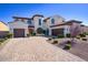 Stately home with a well-manicured lawn, mature trees, and a paved driveway leading to the garage at 5528 E Windstone Trl, Cave Creek, AZ 85331