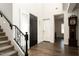 Elegant foyer featuring a staircase with iron railings, wood floors, and a view into the home at 5528 E Windstone Trl, Cave Creek, AZ 85331