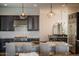 Bright kitchen featuring stainless steel appliances, custom cabinetry, and modern pendant lighting at 5528 E Windstone Trl, Cave Creek, AZ 85331