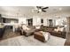 An open-concept living room flows into the dining area with dark wood floors and a neutral color palette at 5528 E Windstone Trl, Cave Creek, AZ 85331