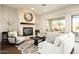 Bright living room with a stone fireplace, stylish seating, and a large window offering ample light at 5528 E Windstone Trl, Cave Creek, AZ 85331
