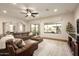 Bright living room features large windows, wood floors, and a comfortable sectional sofa at 5528 E Windstone Trl, Cave Creek, AZ 85331