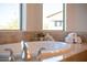 Close-up of a luxurious soaking tub with elegant fixtures, decorative vases, and neatly arranged rolled white towels at 5528 E Windstone Trl, Cave Creek, AZ 85331