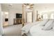 Bright main bedroom featuring a four poster bed, a television on a decorative cabinet, and an ensuite bathroom at 5528 E Windstone Trl, Cave Creek, AZ 85331