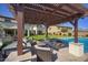 Inviting pool patio with a covered seating area and a cozy fire pit, perfect for outdoor relaxation and entertaining at 5528 E Windstone Trl, Cave Creek, AZ 85331
