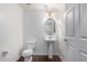 Clean bathroom with pedestal sink and oval mirror at 615 E Portland St # 112, Phoenix, AZ 85004