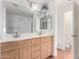 Bathroom with double sinks, wood cabinets, and a bathtub at 615 E Portland St # 112, Phoenix, AZ 85004