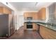 Modern kitchen with wood cabinets and stainless steel appliances at 615 E Portland St # 112, Phoenix, AZ 85004