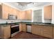 Modern kitchen with wood cabinets and stainless steel appliances at 615 E Portland St # 112, Phoenix, AZ 85004