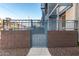Private gated patio area with brick wall at 615 E Portland St # 112, Phoenix, AZ 85004