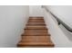 Wooden stairs with a gray metal handrail at 615 E Portland St # 112, Phoenix, AZ 85004