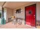 Inviting front porch with red door and small sitting area at 710 E Hayward Ave, Phoenix, AZ 85020