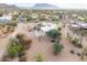 Aerial view of a house with a large yard, desert landscaping, and mountain views at 751 E Moon Vista St, Apache Junction, AZ 85119