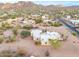 Aerial view showcasing a house's exterior, expansive desert lot, and mountain backdrop at 751 E Moon Vista St, Apache Junction, AZ 85119