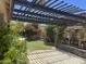 Beautiful backyard with artificial grass, pergola, outdoor fireplace, and lush landscaping at 758 S Lagoon Dr, Gilbert, AZ 85233