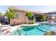 Inviting backyard oasis featuring a sparkling pool, expansive patio, and lush landscaping at 758 S Lagoon Dr, Gilbert, AZ 85233