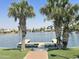 Dock view over the lake on a beautiful sunny day surrounded by lush green grass at 758 S Lagoon Dr, Gilbert, AZ 85233