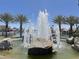 Water fountain featuring decorative stones and palm trees with waterfront homes in the background at 758 S Lagoon Dr, Gilbert, AZ 85233