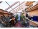 Indoor greenhouse with various plants and shelves at 758 S Lagoon Dr, Gilbert, AZ 85233