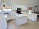 Modern kitchen featuring white cabinetry, quartz countertops, and tile flooring at 758 S Lagoon Dr, Gilbert, AZ 85233