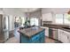 Kitchen island with granite countertop and teal cabinetry at 758 S Lagoon Dr, Gilbert, AZ 85233