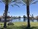 Scenic lake view with palm trees, a bench, and beautiful waterfront homes at 758 S Lagoon Dr, Gilbert, AZ 85233