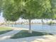 Beautiful lake view surrounded by lush green trees and clear blue sky at 758 S Lagoon Dr, Gilbert, AZ 85233