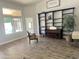 Open living room with natural light, tile flooring, piano, and custom shelving at 758 S Lagoon Dr, Gilbert, AZ 85233