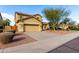 Two-story house with tan exterior, landscaped yard, and a two-car garage at 7712 S 72Nd Ave, Laveen, AZ 85339