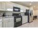 White kitchen cabinets, granite counters, and black appliances at 8082 E Via Del Desierto --, Scottsdale, AZ 85258