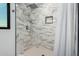 Spacious shower with marble tile and built-in niche at 8556 E Sage Dr, Scottsdale, AZ 85250