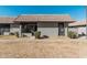 Front view of a charming single story home with tile roof and landscaping at 9027 W Elm St # 5, Phoenix, AZ 85037